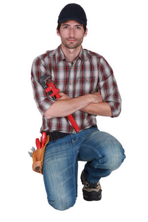 Craftsman on his kneesの写真素材
