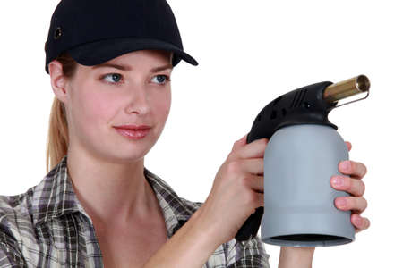Woman with a blowtorchの写真素材