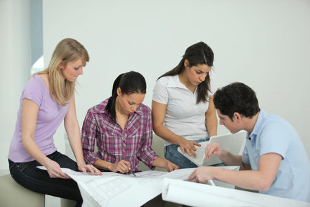 Team discussing drawings