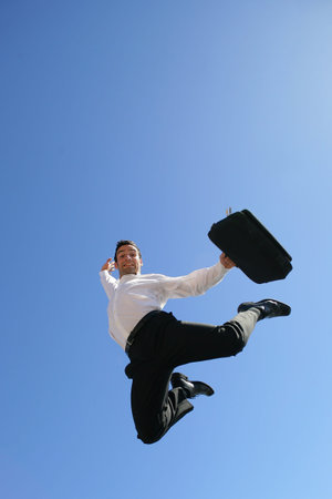Ecstatic businessman leaping through the air