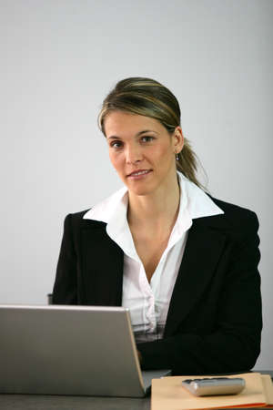 Blond accountant sat at deskの写真素材