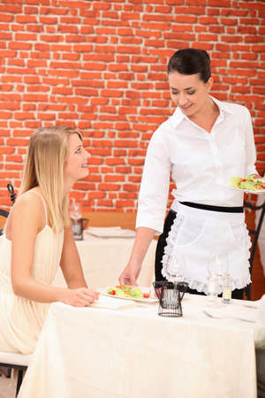 Waitress serving plateの写真素材
