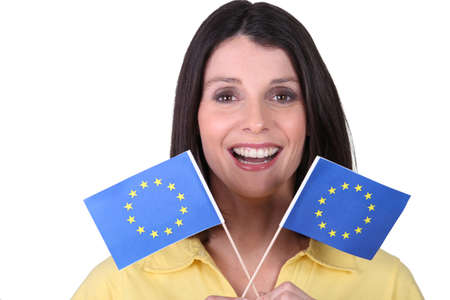 brunette  brandishing European flagsの写真素材