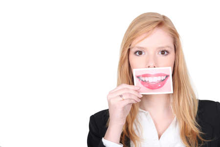Woman with picture in front of her mouthの写真素材