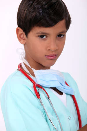 Young boy pretending to be a doctorの写真素材