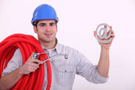 Man holding tap cable and at symbolの写真素材