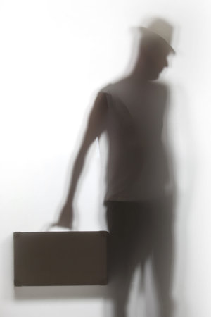 A shadow of a man holding a briefcase.の写真素材