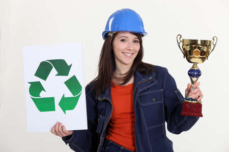 Woman holding trophy and recycle logoの写真素材