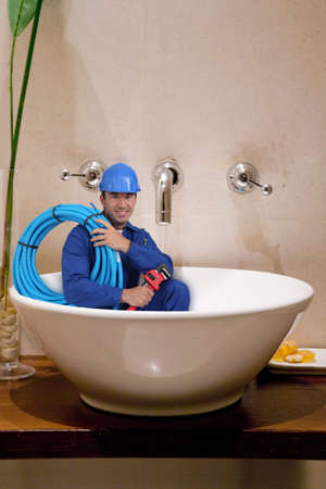 "reduced size" plumber in washbowlの写真素材