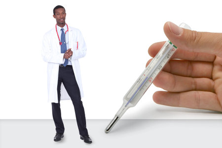 black doctor with giant white hand resting on table holding thermometer beside him