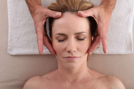 Woman having a head massageの写真素材