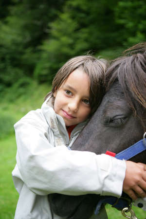 Child stroking horseの写真素材