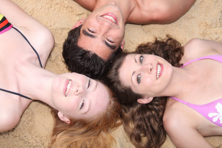 Friends lying on a beach