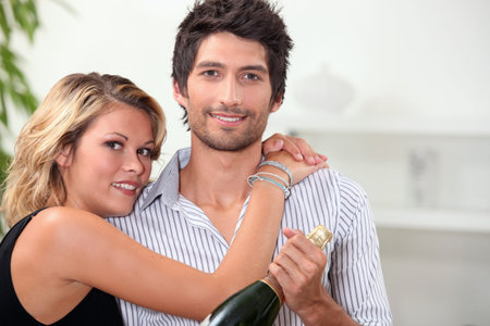 Couple with bottle of champagneの写真素材