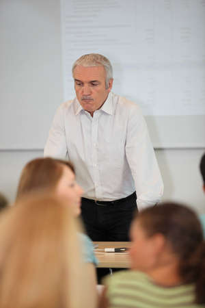 Male teacher stood at front of classroomの写真素材