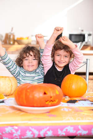 Happy children with carved pumpkinsの写真素材