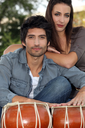 a couple posing near djembe