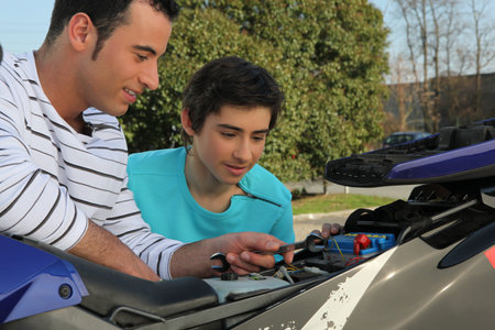 A father and son doing mechanic.