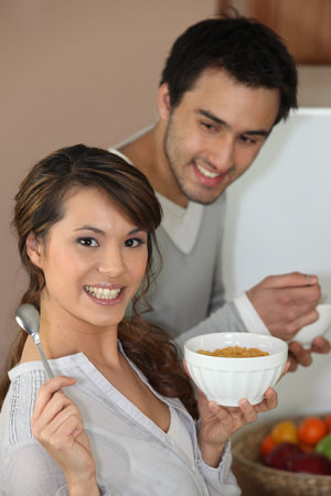 Couple having breakfast standing up