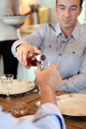 Man pouring wine during meal