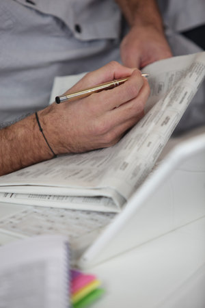 Man reading classified adsの写真素材