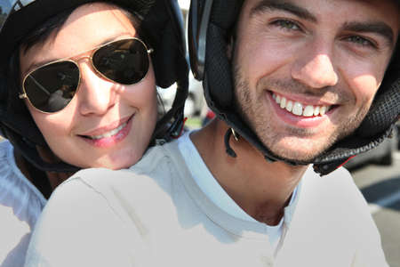 couple riding their scooterの写真素材