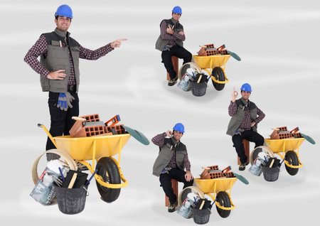 Mason transporting equipment in wheelbarrowの写真素材