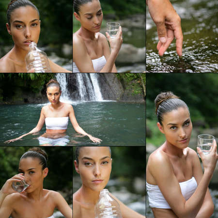 young woman drinking water near a waterfallの写真素材