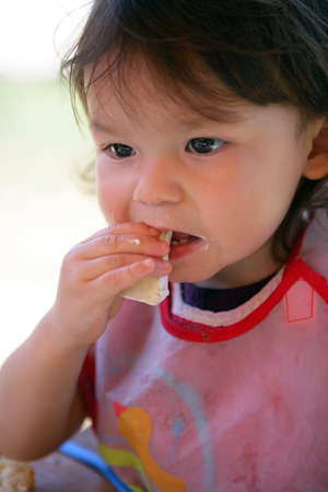 Little girl eating her lunchの写真素材