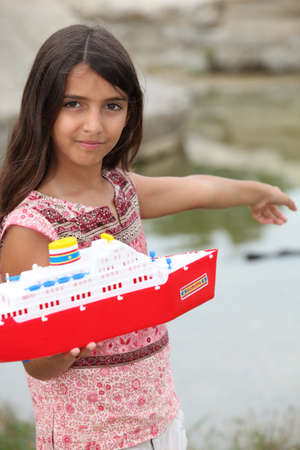 Little girl playing at a riversideの写真素材