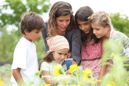 children having a nature class in the park