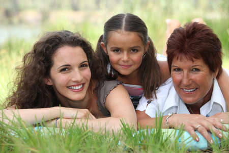 Grandmother, mother and daughter lying in the grass Grandmother, mother and daughter lying in the grass