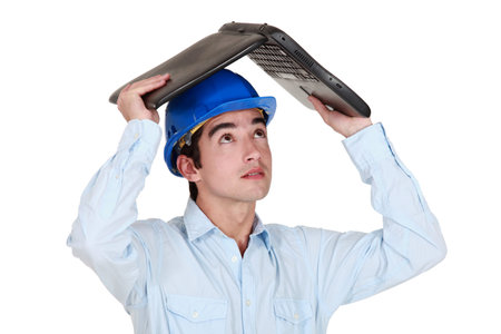 Man sheltering under his laptop