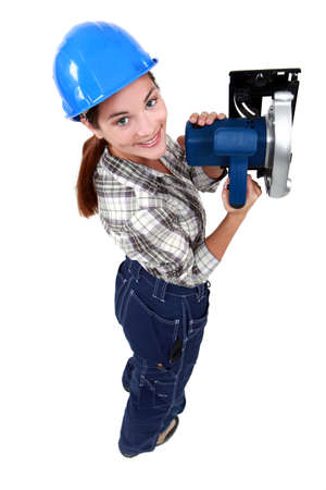 craftswoman holding an electric sawの写真素材