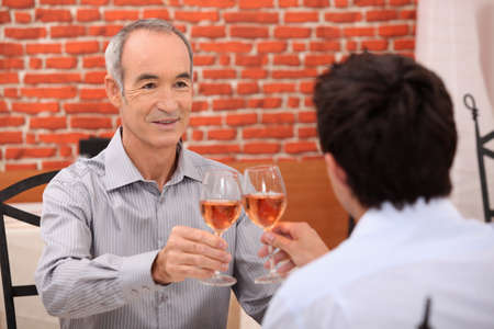 Father and son eating in restaurantの写真素材