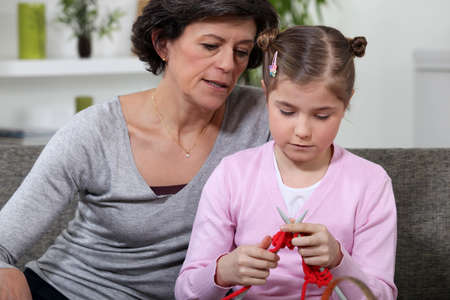 Knitting Grandmother and granddaughterの写真素材