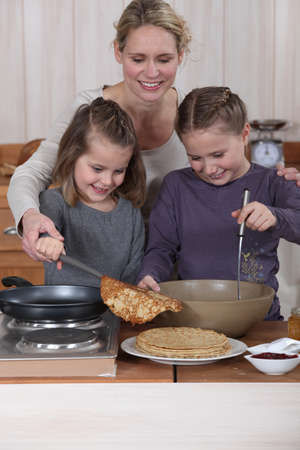Family cooking pancakesの写真素材