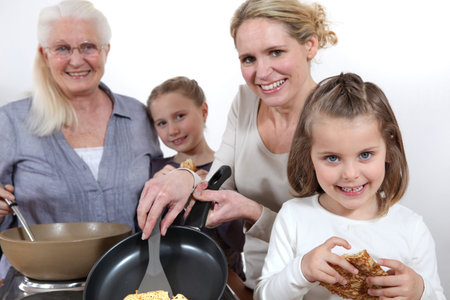 Three generations cooking pancakes