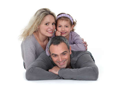 Young family laying on the floor togetherの写真素材