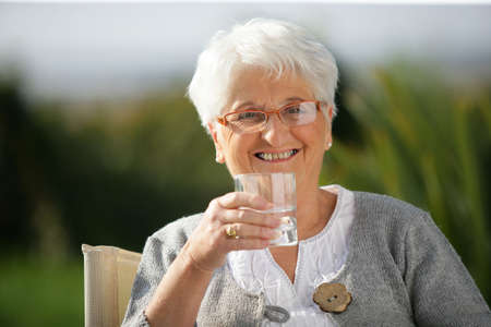 Senior woman with a glass of waterの写真素材
