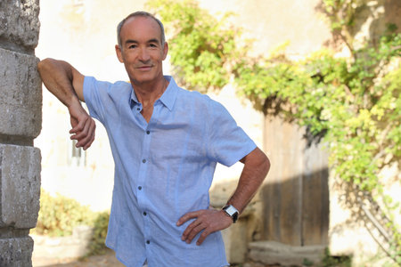 Senior man in front of house