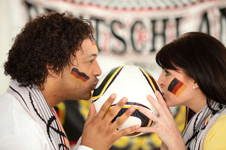 German soccer fans kissing ballの写真素材