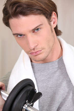 Young man with a barbellの写真素材