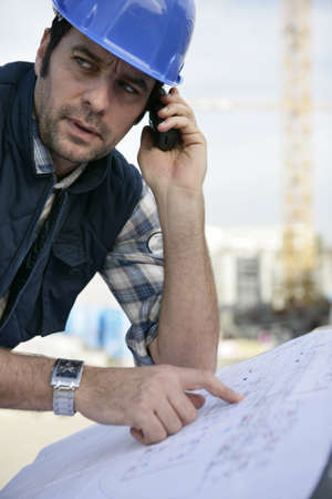 Architect unsure about blueprintsの写真素材