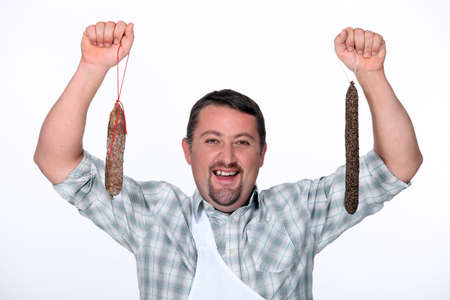 Man holding cured sausagesの写真素材