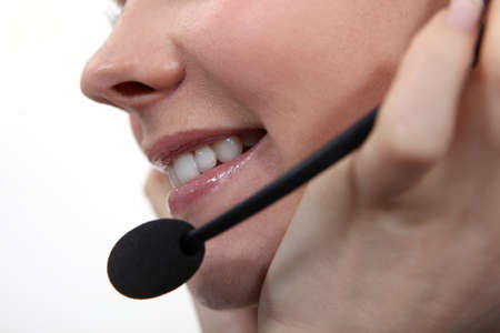 Closeup of a woman speaking into a microphoneの写真素材