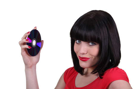 brunette woman showing a compact discの写真素材