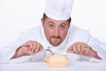 Chef eating a polystyrene foam takeaway box