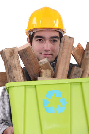 Man carrying wood to be recycledの写真素材