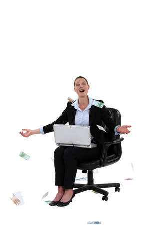 Overjoyed woman throwing money in the airの写真素材